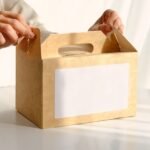 Woman packing box with food placed on table